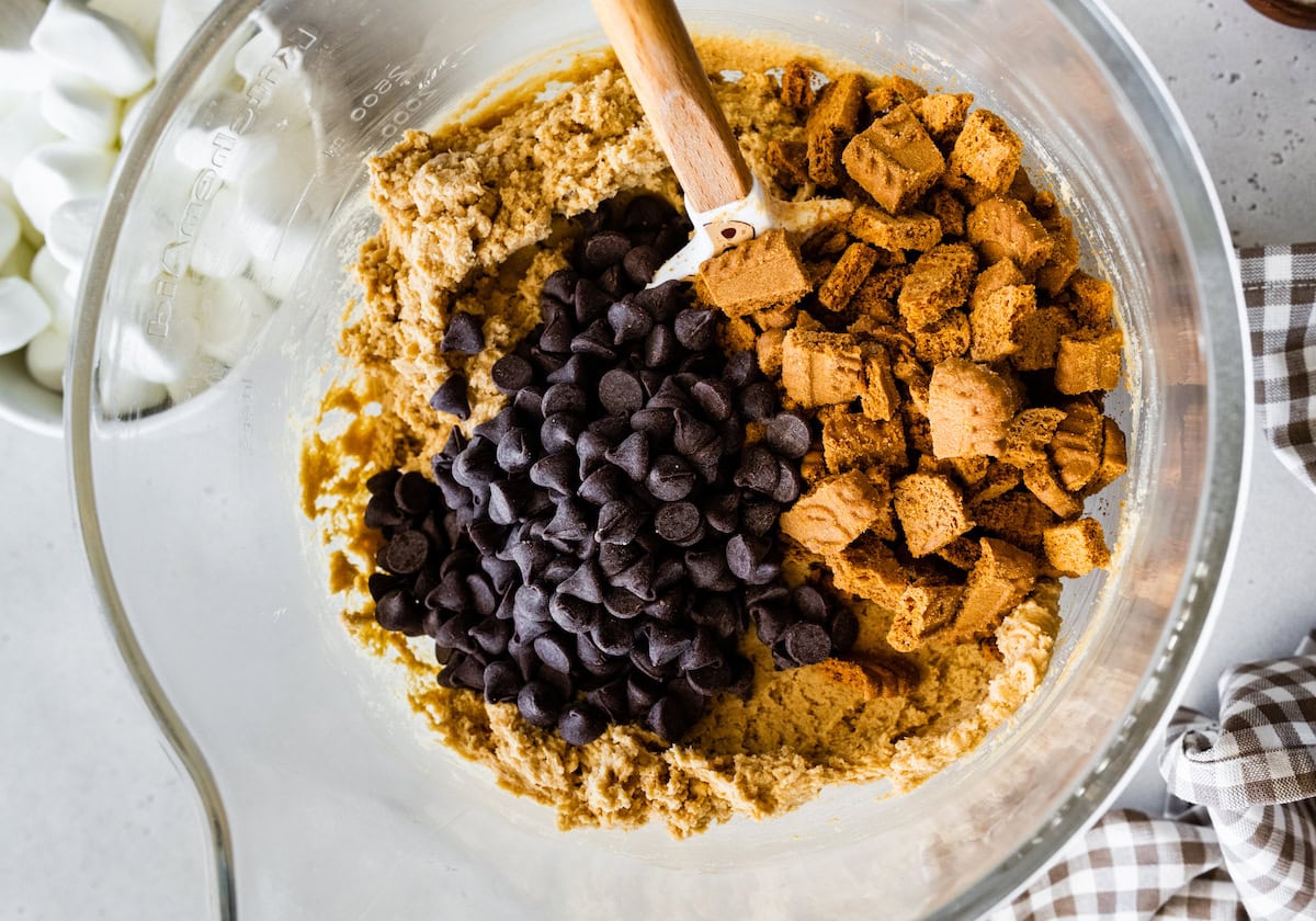 biscoff s'mores cookie dough in mixing bowl with spatula.