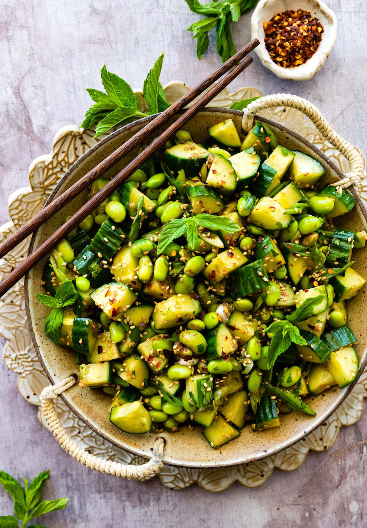 Cucumber Edamame Salad in bowl with chopsticks.