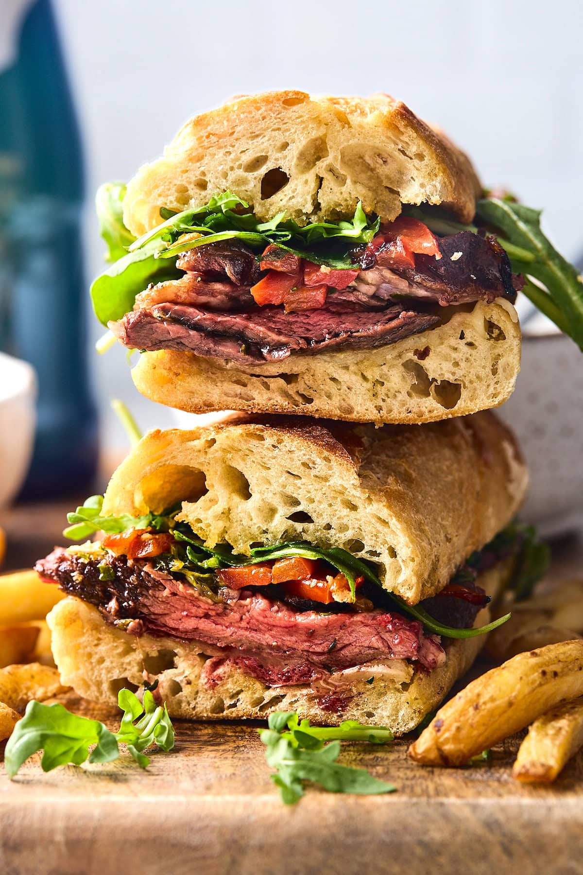 steak sandwich cut in half and stacked on top of each other.