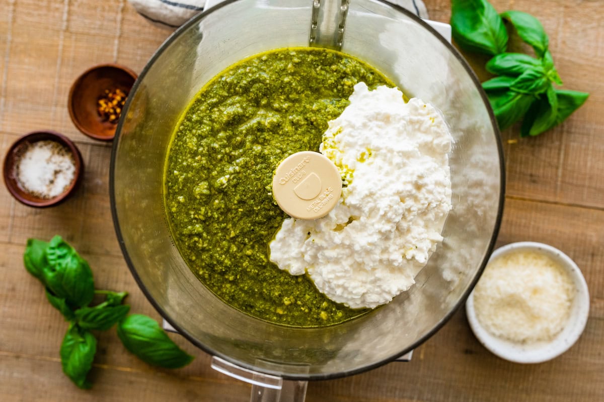 cottage cheese and pesto in food processor bowl.