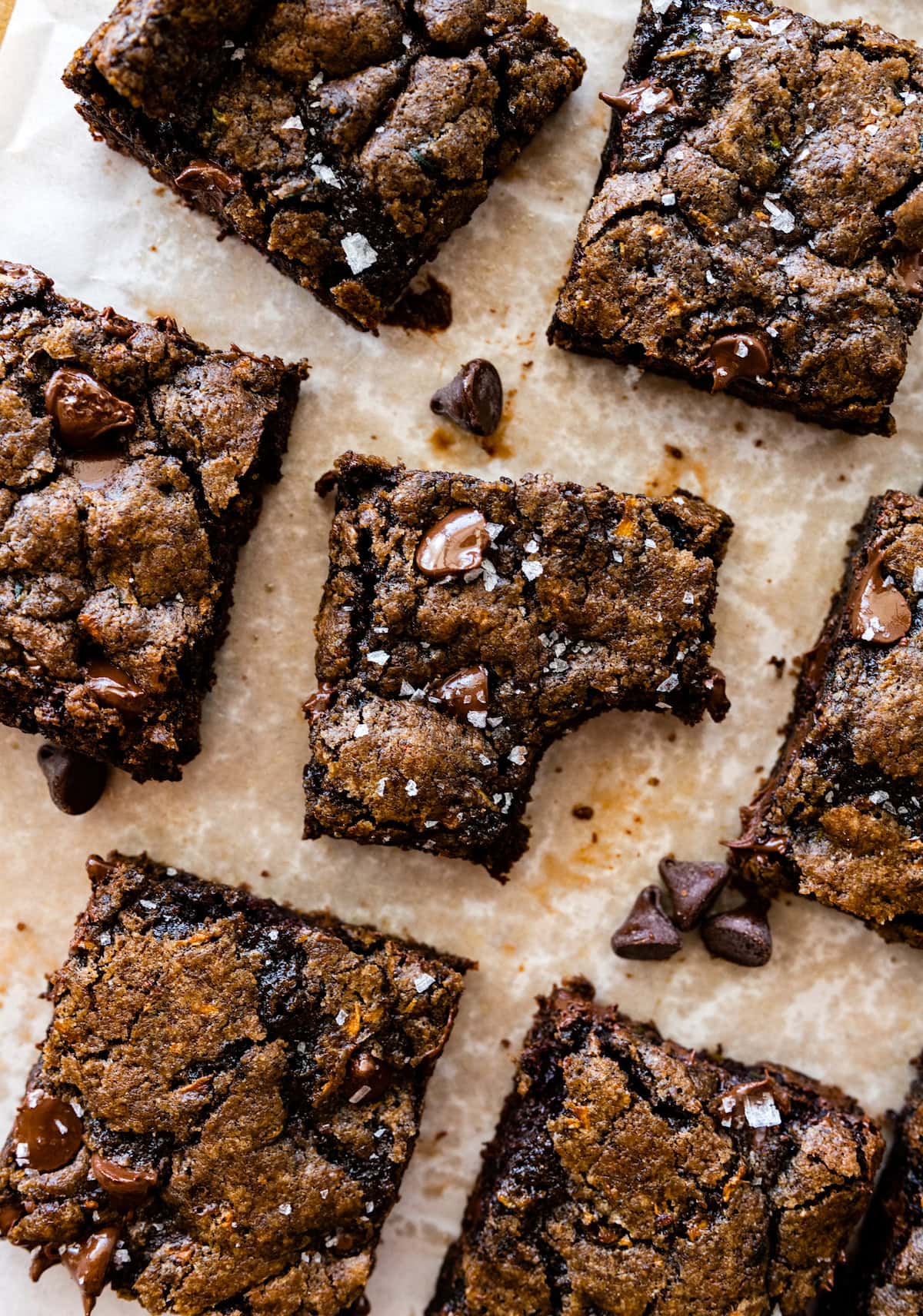 zucchini brownies cut into squares with one missing a bite.