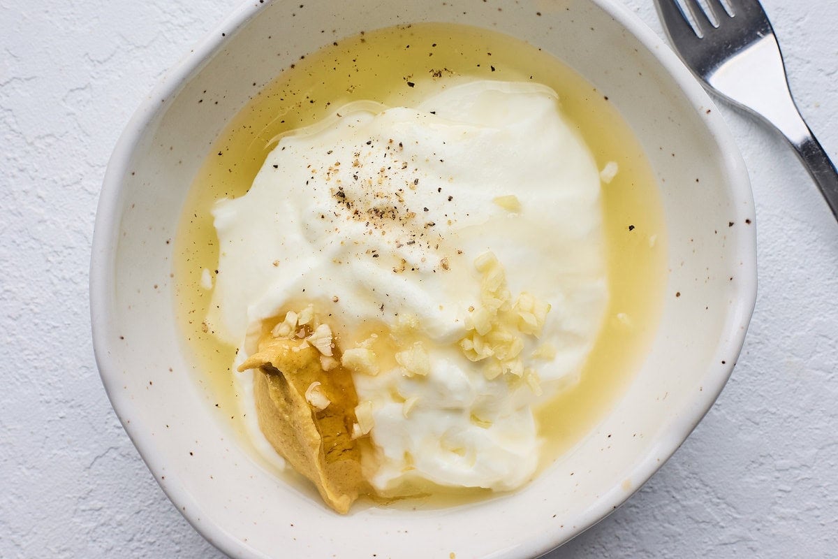 creamy lemon dressing in bowl ready to be mixed.