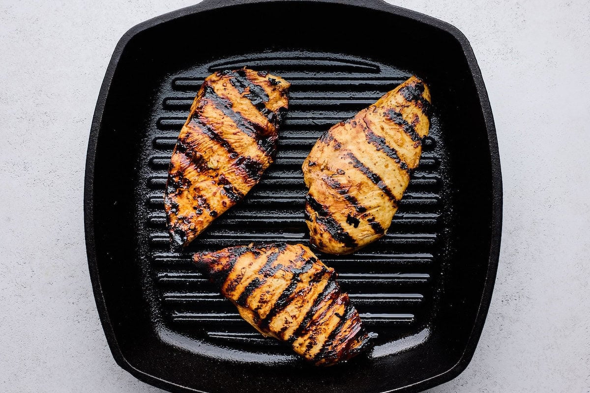hot honey chicken grilling on grill pan.
