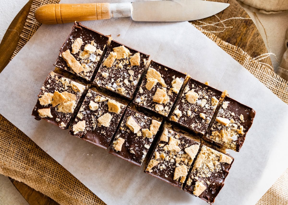 no bake peanut butter s'mores bars cut into squares on parchment paper.