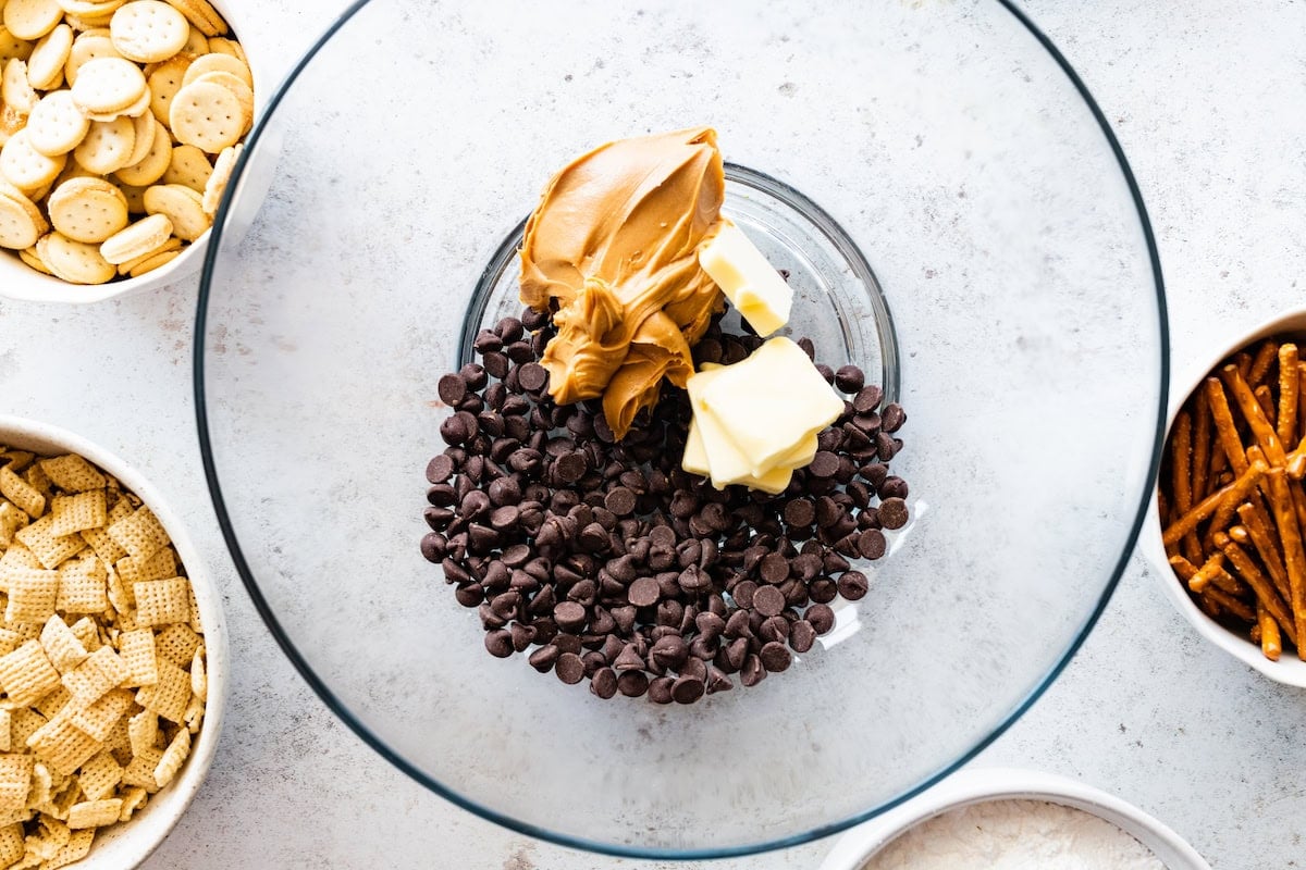 chocolate chips, butter, and peanut butter in glass mixing bowl.