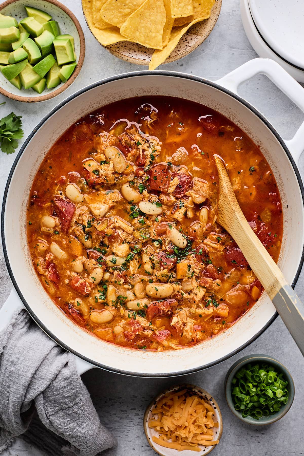 buffalo chicken chili in pot with wooden spoon.