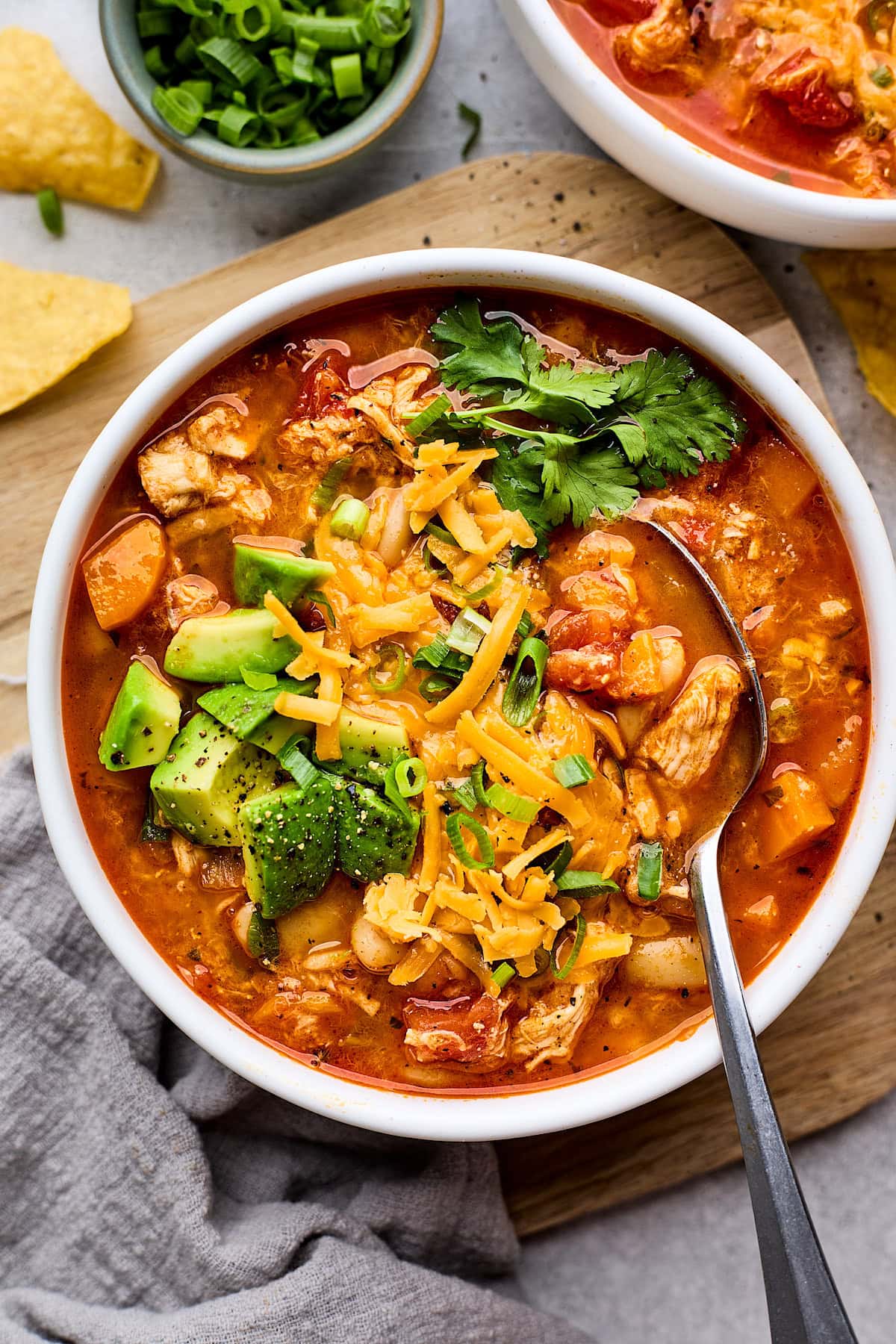 buffalo chicken chili in bowl with spoon.