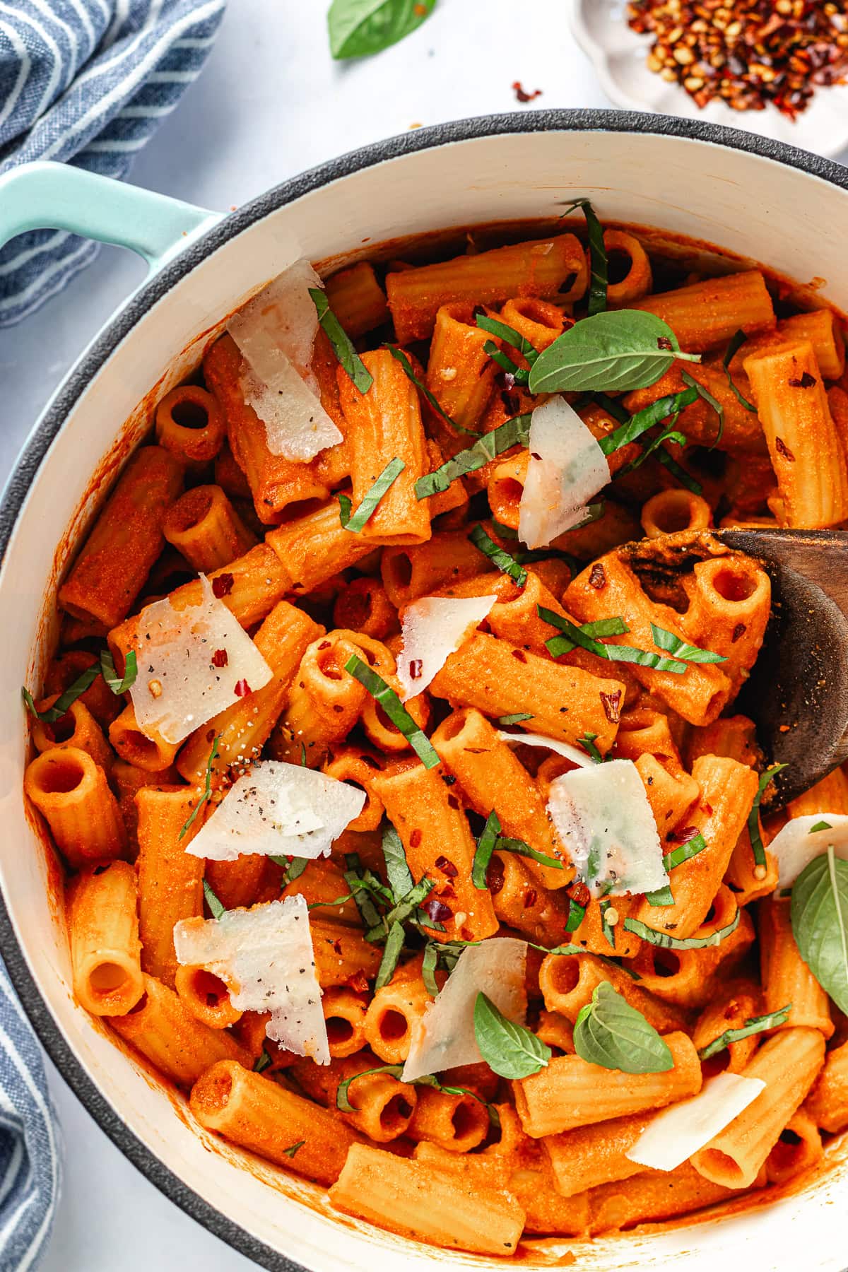 cottage cheese pasta sauce with rigatoni noodles in pot with parmesan cheese and basil.