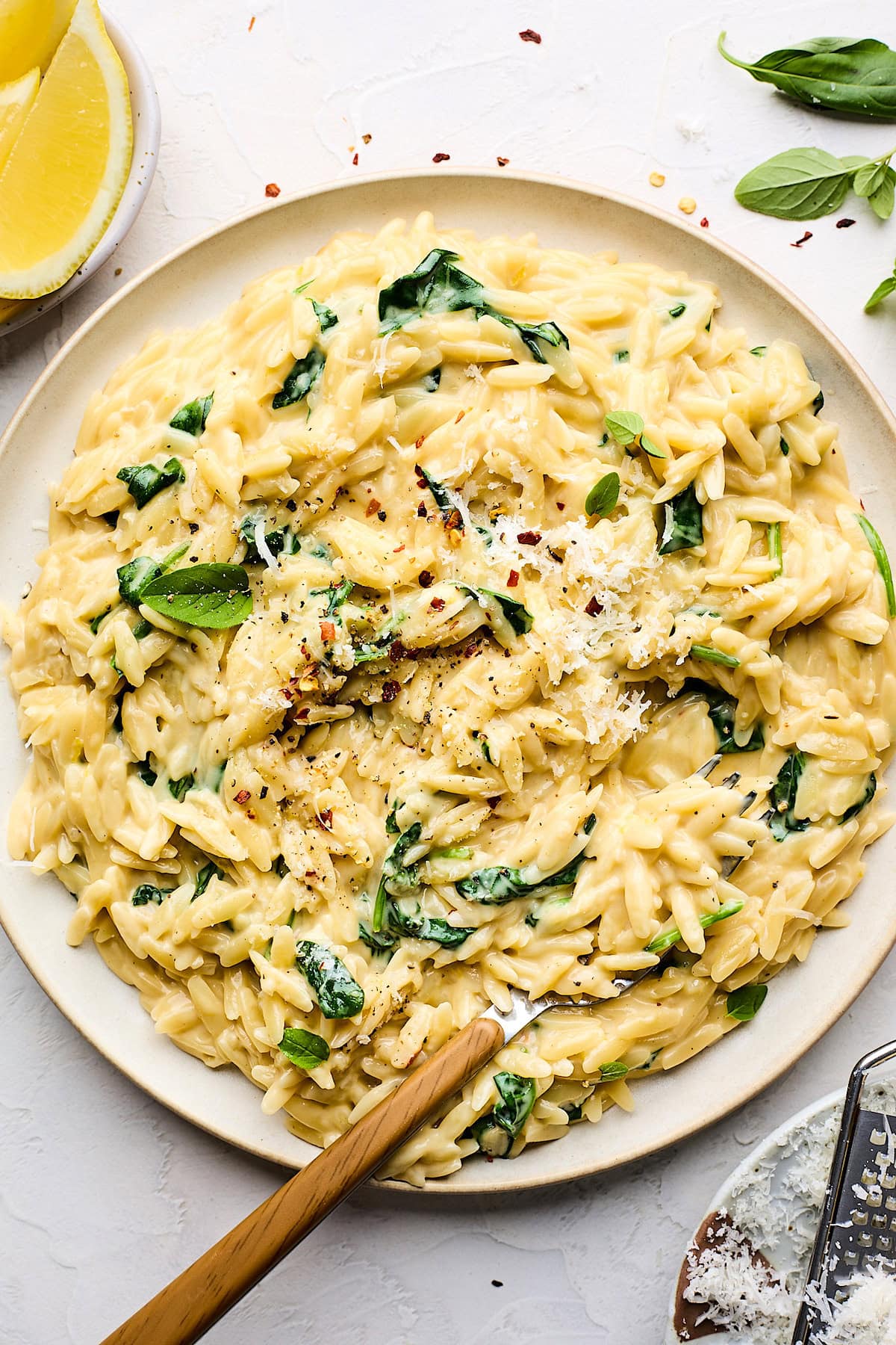 creamy orzo on plate with fork.