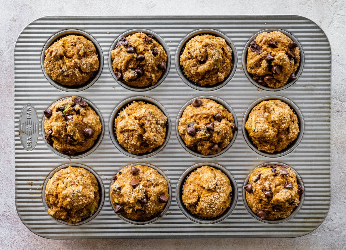 pumpkin zucchini muffins in muffin pan.