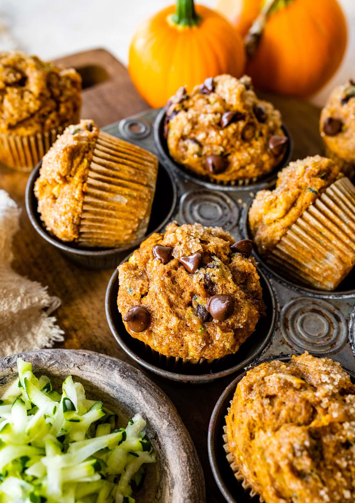 pumpkin zucchini muffins with chocolate chips in muffin pan.