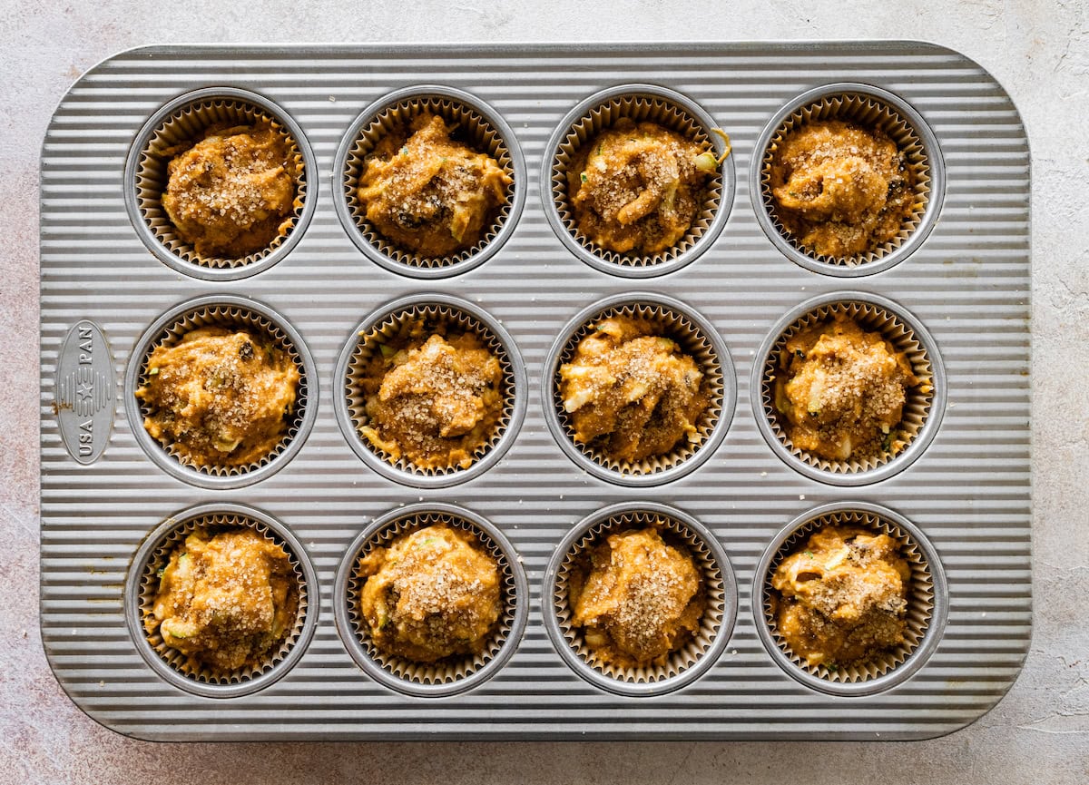 pumpkin zucchini muffin batter in muffin pan.