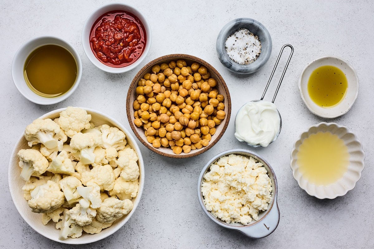 ingredients in bowls to make roasted cauliflower chickpea wraps.