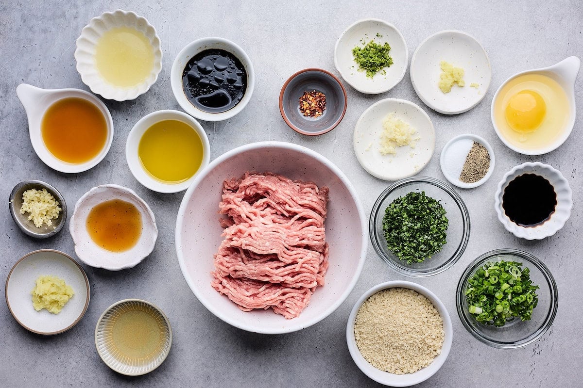 ingredients in bowls to make Asian meatballs.