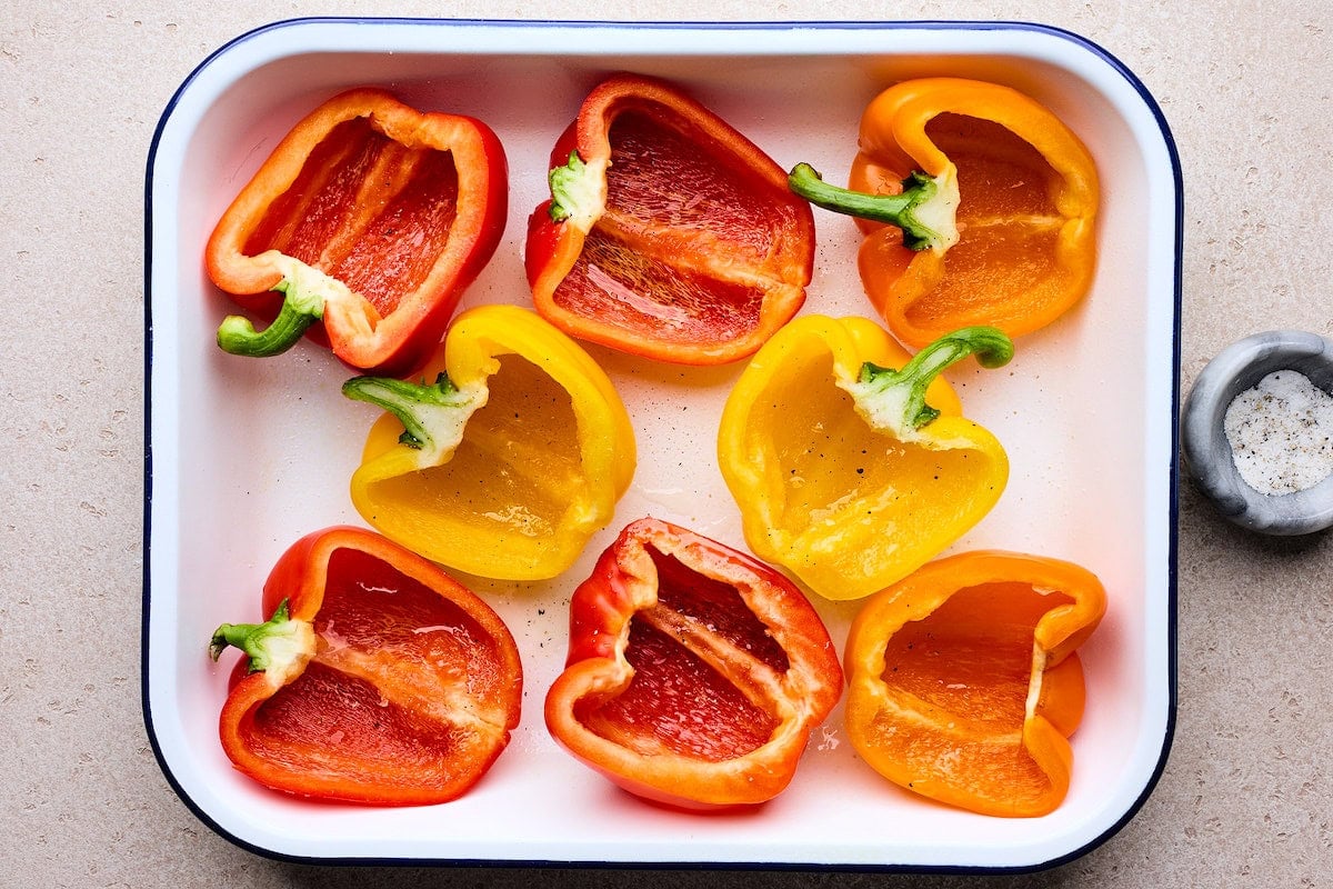 bell peppers cut in half in pan to make stuffed peppers.