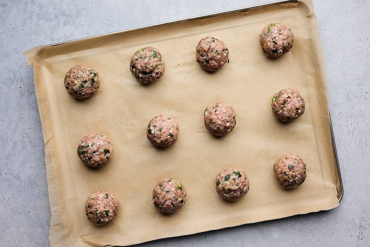 soy ginger meatballs on baking sheet with parchment paper.