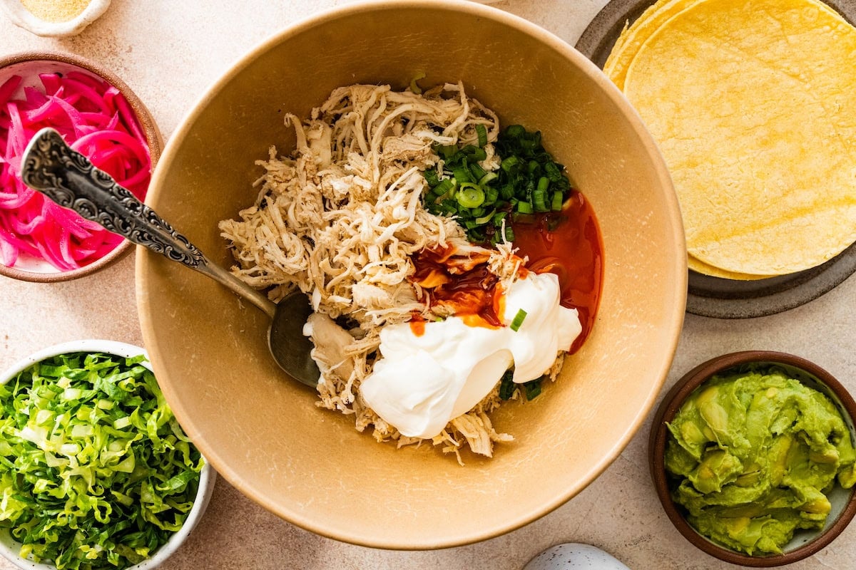 shredded chicken, Greek yogurt, buffalo sauce, garlic powder and green onion in mixing bowl.