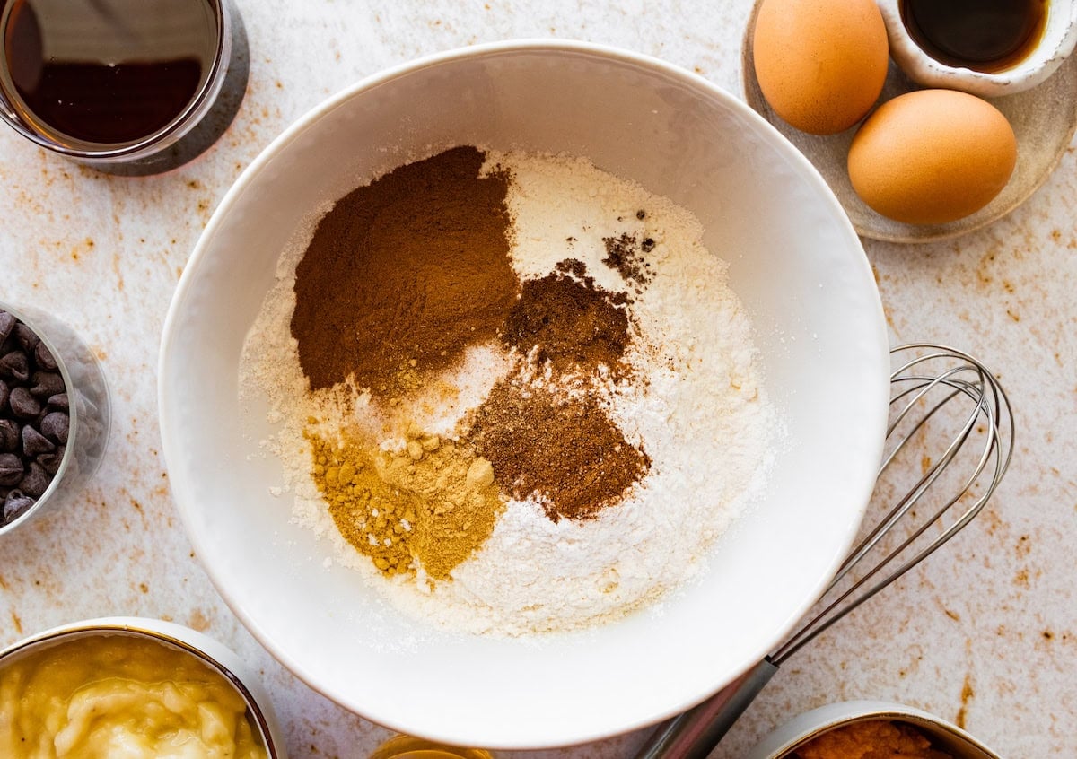 dry ingredients in mixing bowl to make pumpkin banana muffins.