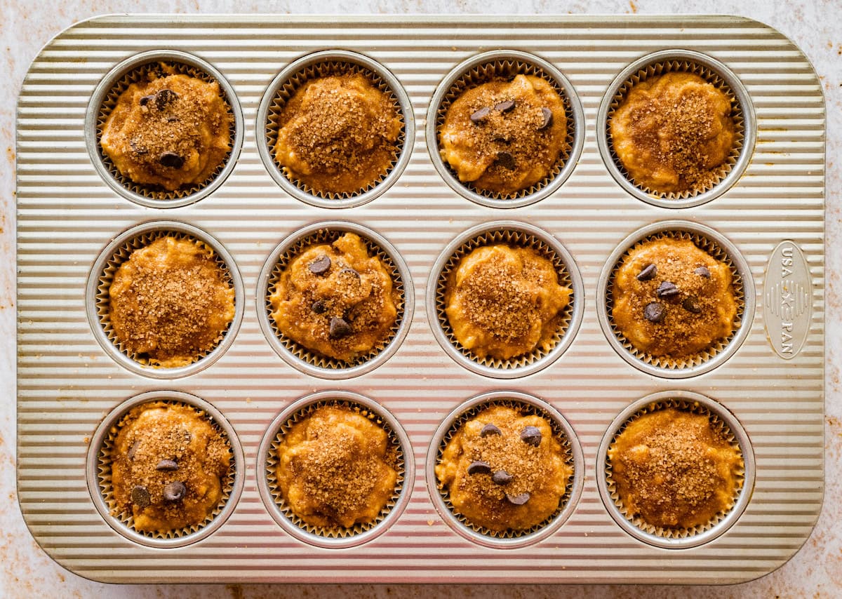 pumpkin banana muffins in pan ready for the oven.