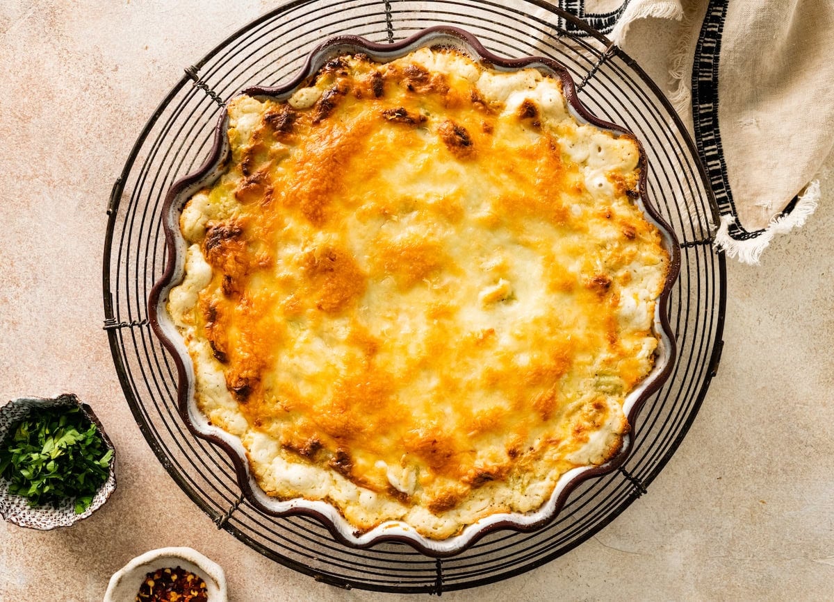 baked artichoke dip on cooling rack.