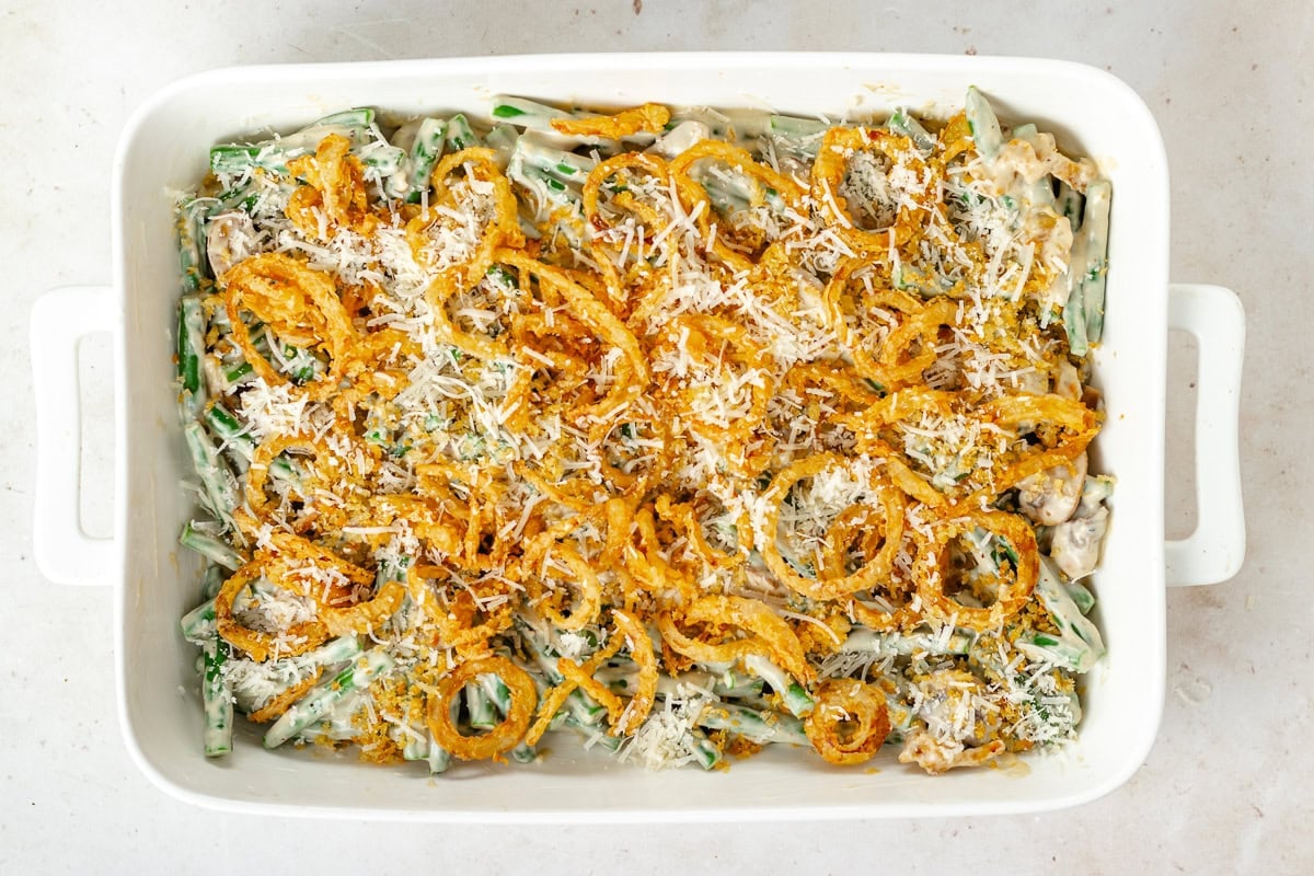 green bean casserole in baking dish getting ready to go in oven.