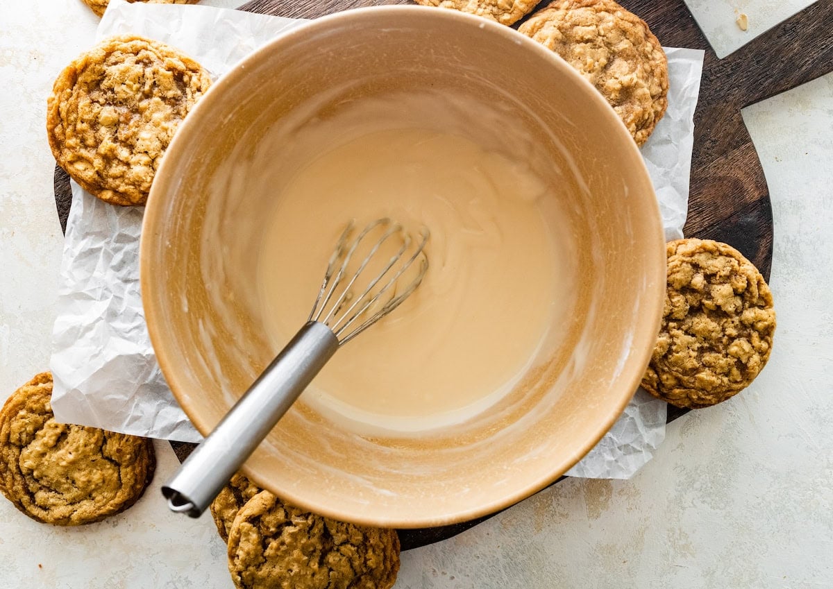 icing in mixing bowl with whisk to make iced oatmeal cookies.
