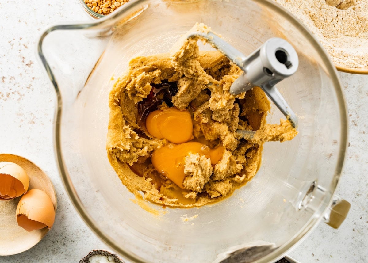 creamed butter and sugars in mixing bowl with eggs and vanilla extract.