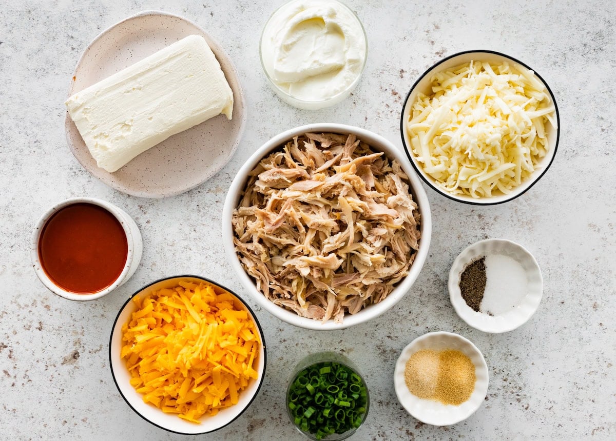 ingredients in bowls to make buffalo chicken dip.