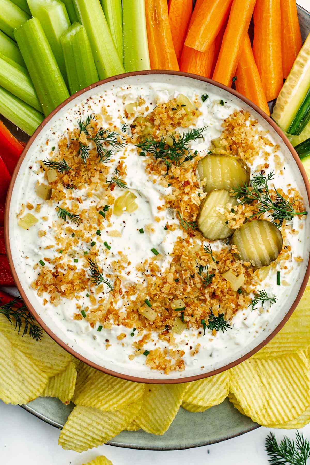 dill pickle pickle dip with toasted breadcrumbs in bowl.