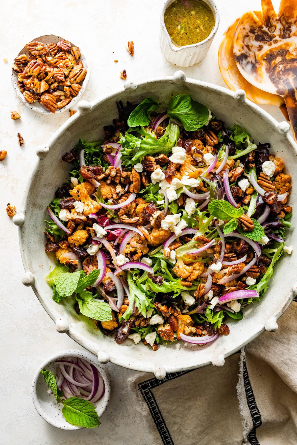 Roasted Cauliflower Salad with dates, salted maple pecans, goat cheese, red onion, and an orange maple vinaigrette.