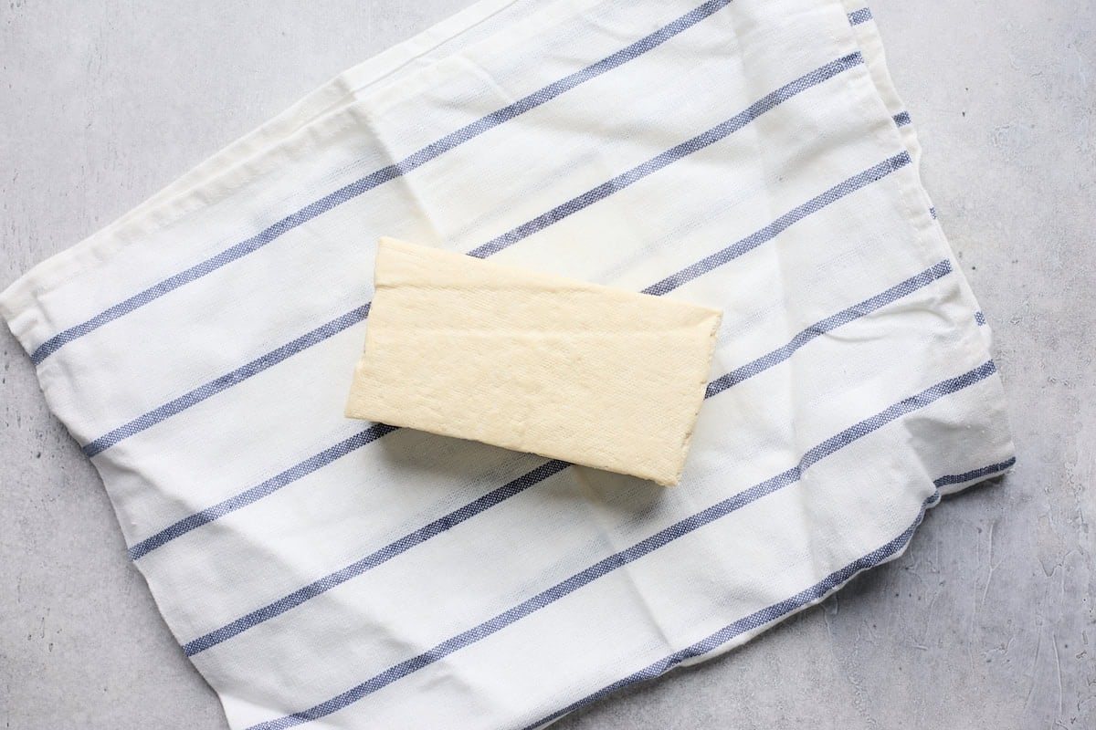 tofu block on towel to drain out liquid.