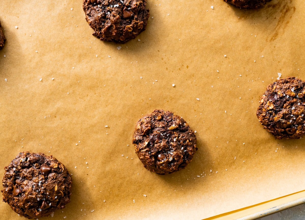 healthy chocolate cookies on baking sheet with parchment paper.