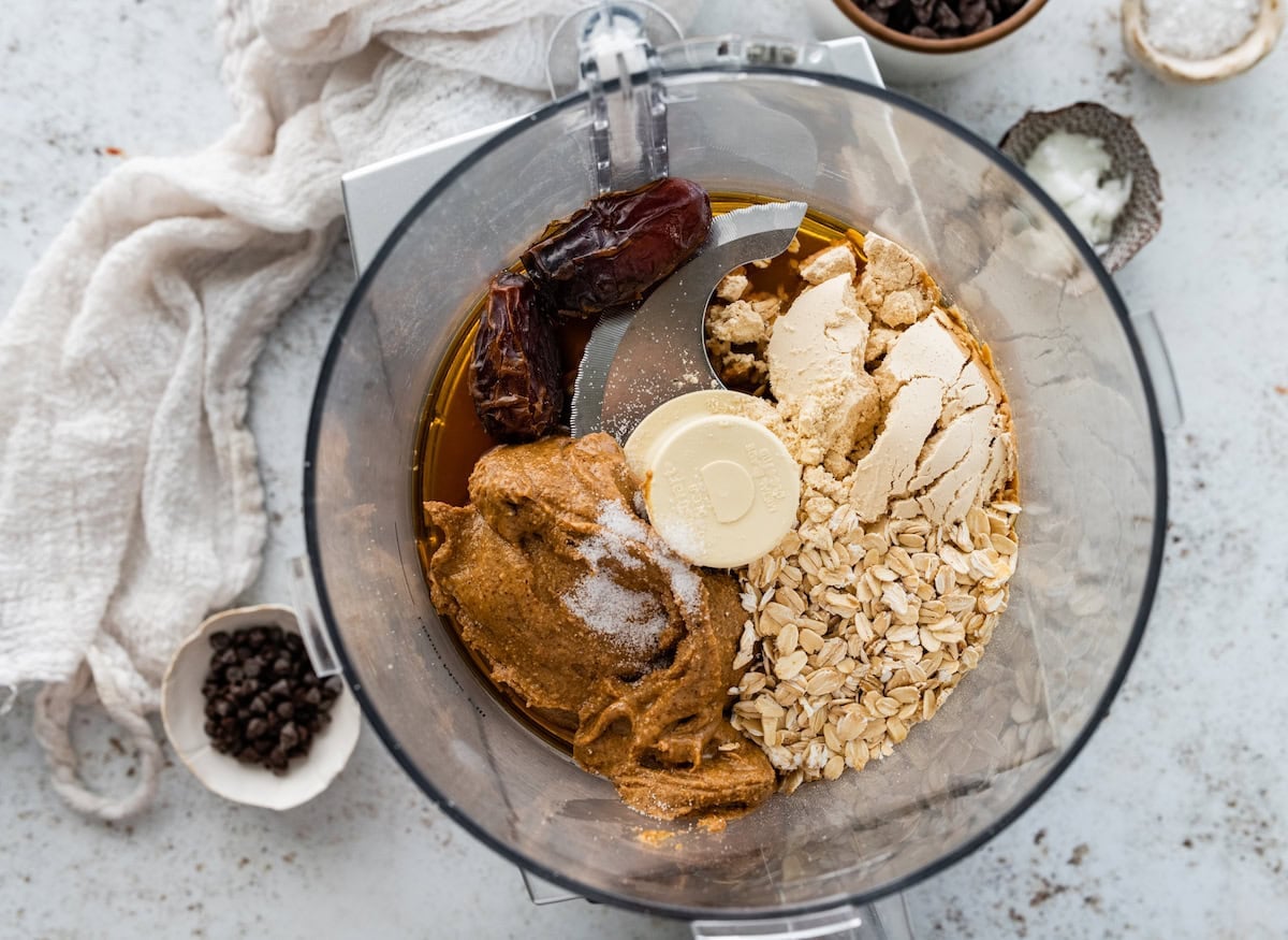 almond butter, oats, protein powder, dates, maple syrup, and salt in food processor.