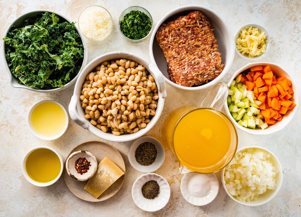 ingredients in bowls to make sausage kale white bean soup.
