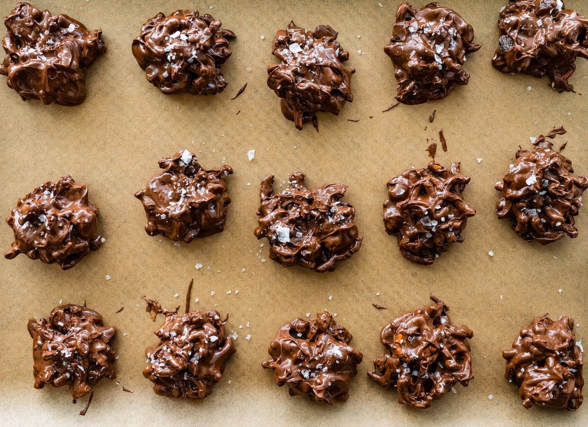 peanut butter pretzel date clusters with flaky sea salt on baking sheet.