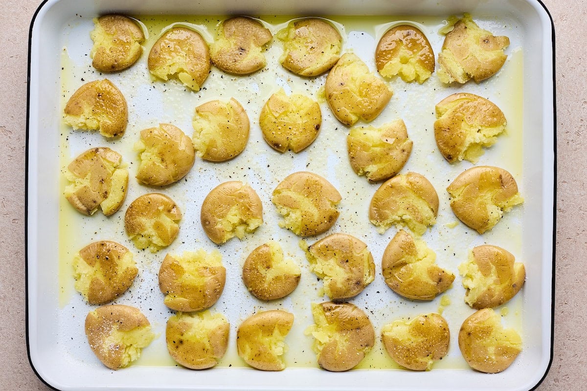 smashed potatoes on baking sheet.