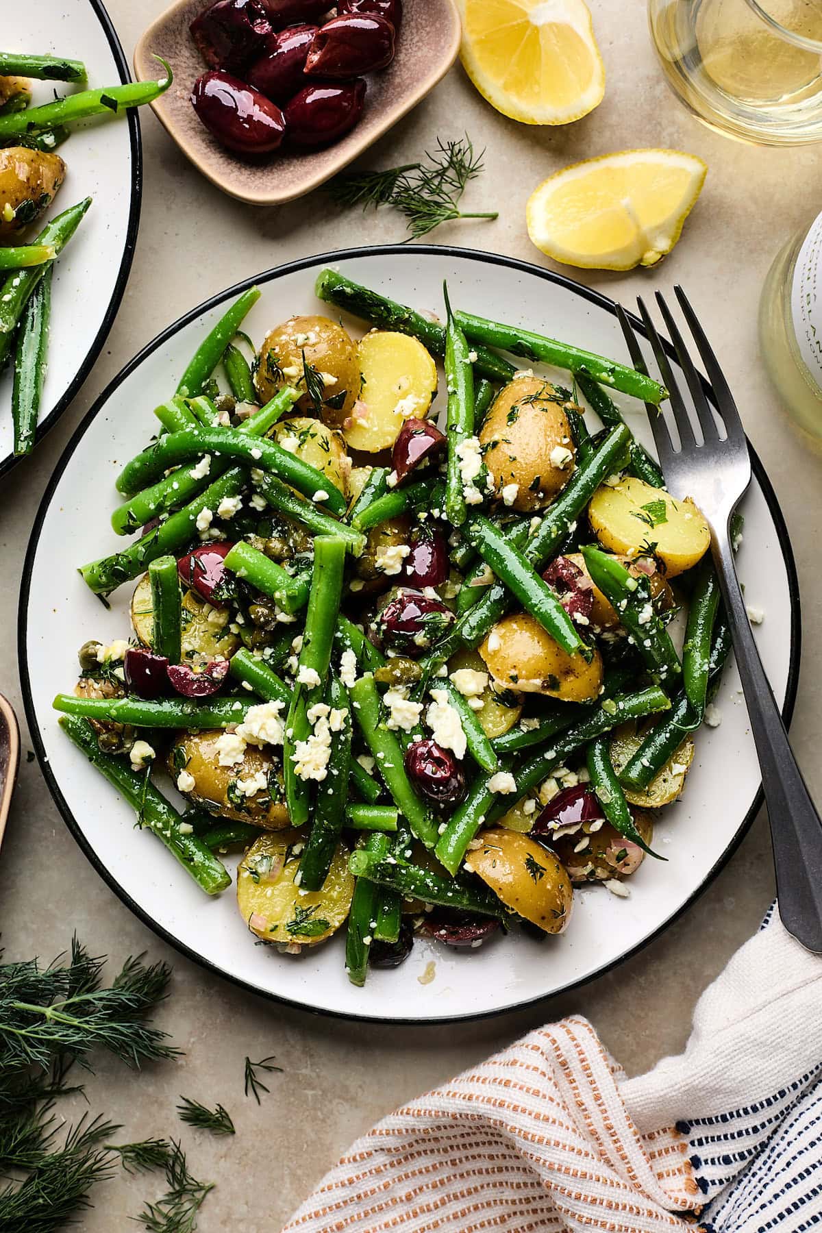 potato and green bean salad on plate with fork.