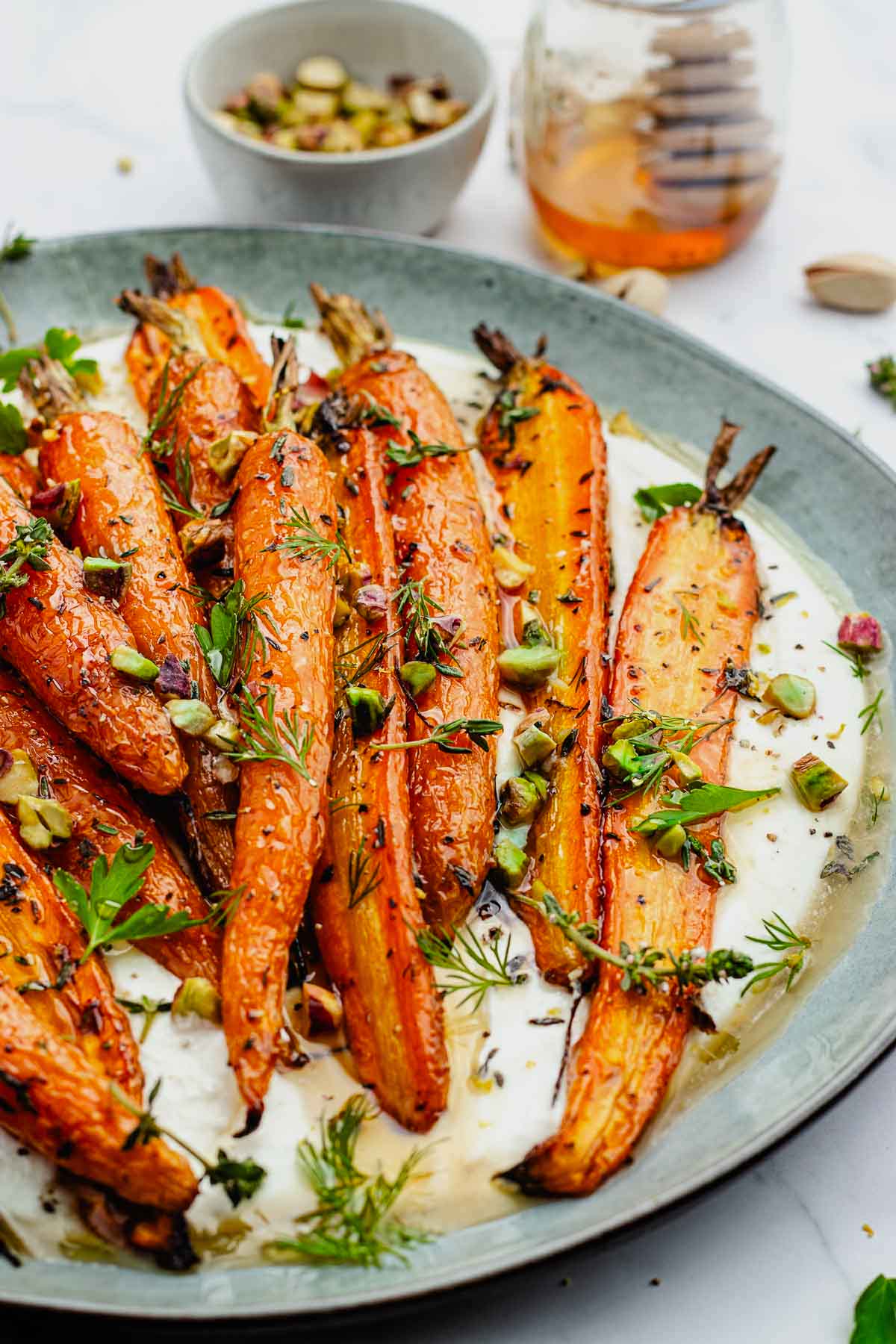 roasted carrots with whipped feta with pistachios, herbs, and honey.