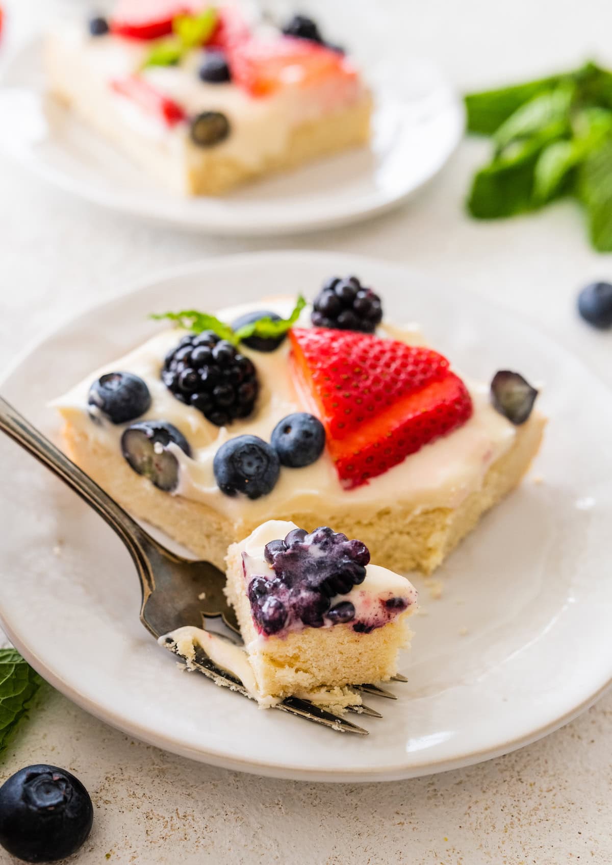 sugar cookie fruit pizza bars on plate with fork.
