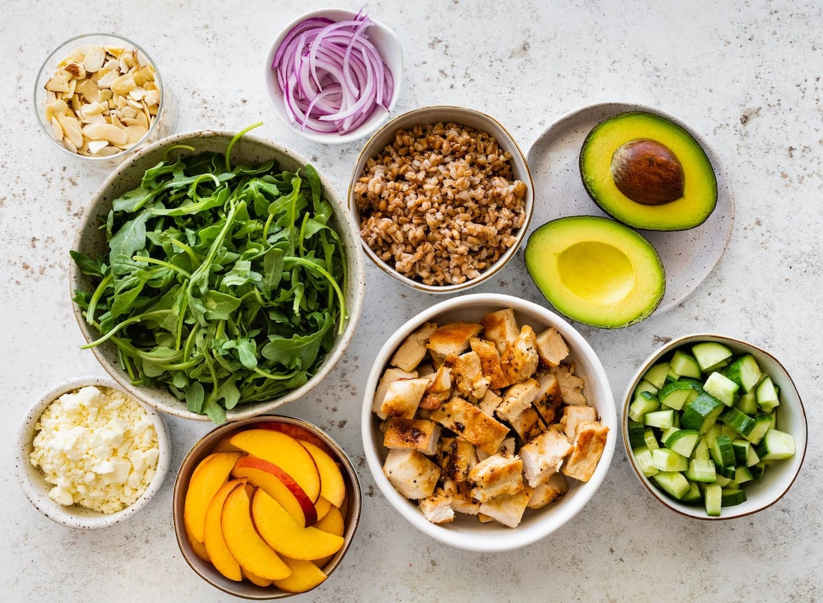 ingredients in bowls to make summer chicken salad.