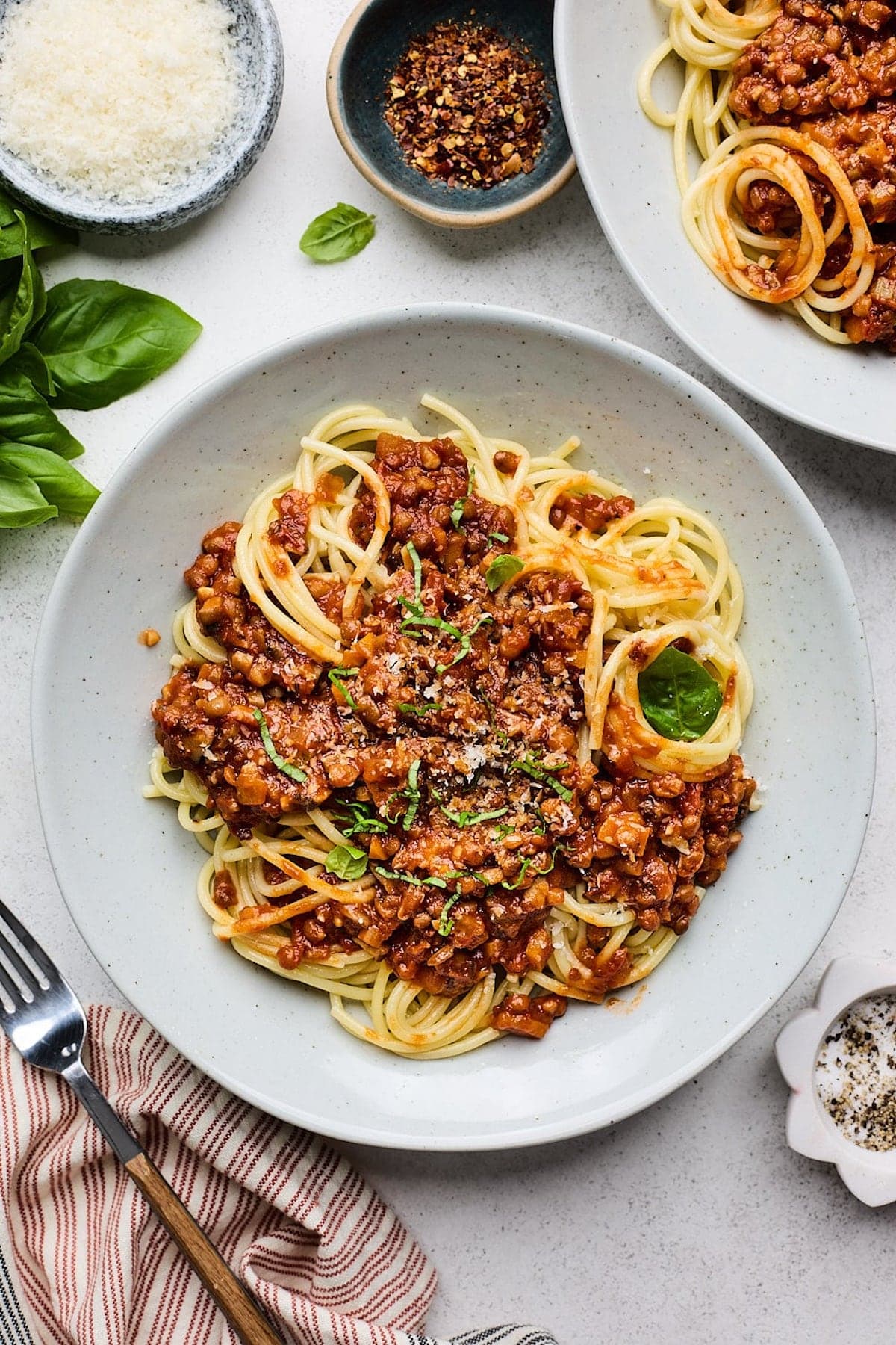 lentil bolognese over spaghetti in bowl.