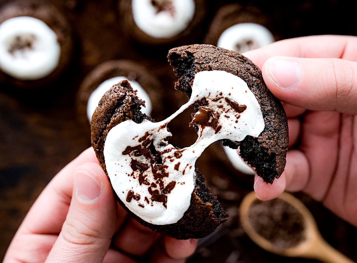 hot cocoa cookie being pulled apart with gooey marshmallow center. 
