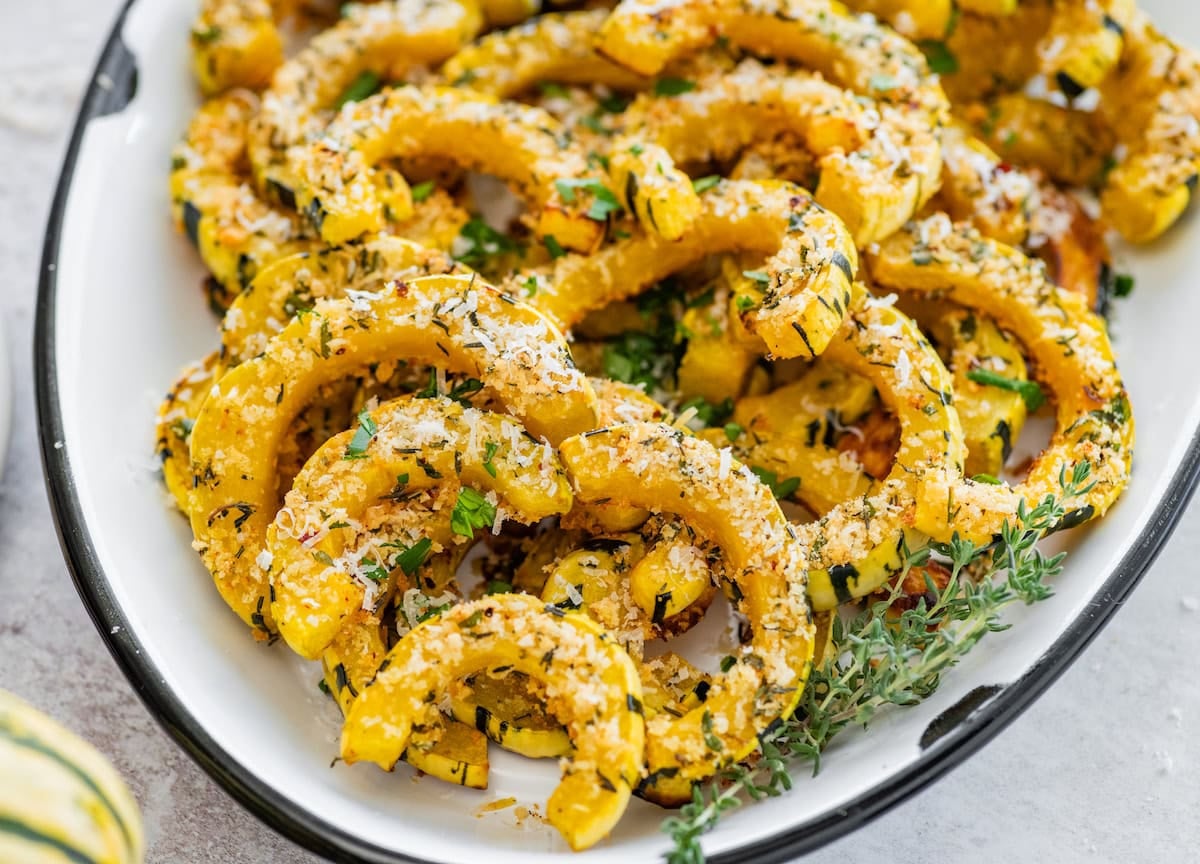 close up of Parmesan roasted delicata squash with fresh thyme.