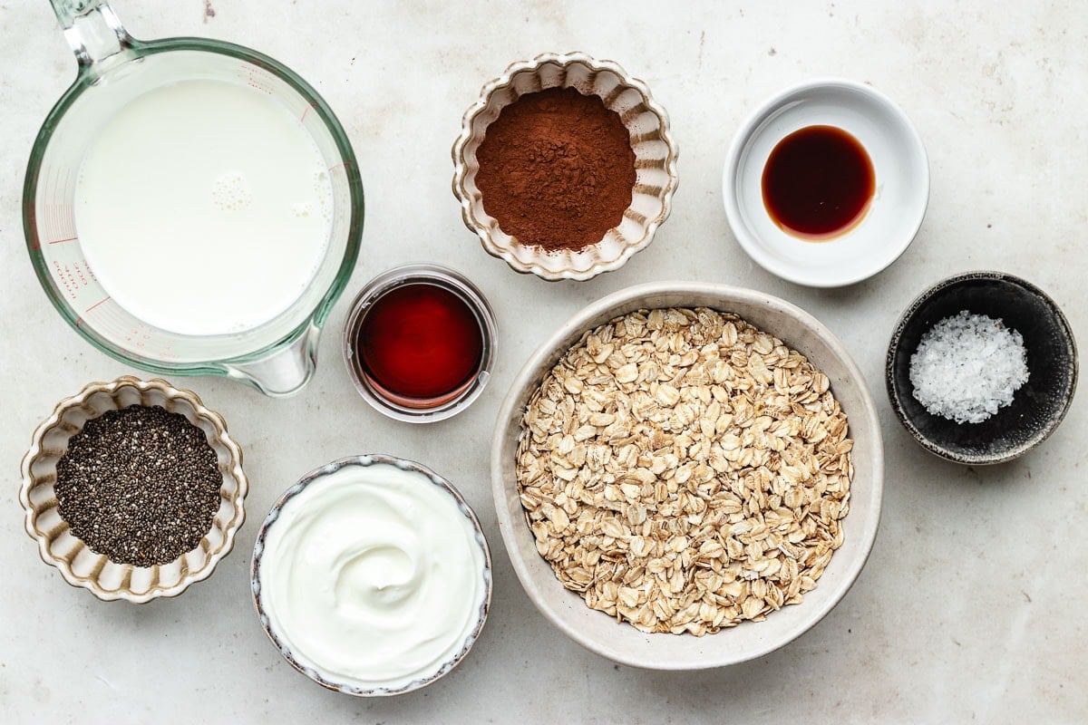 ingredients in bowls to make chocolate overnight oats.