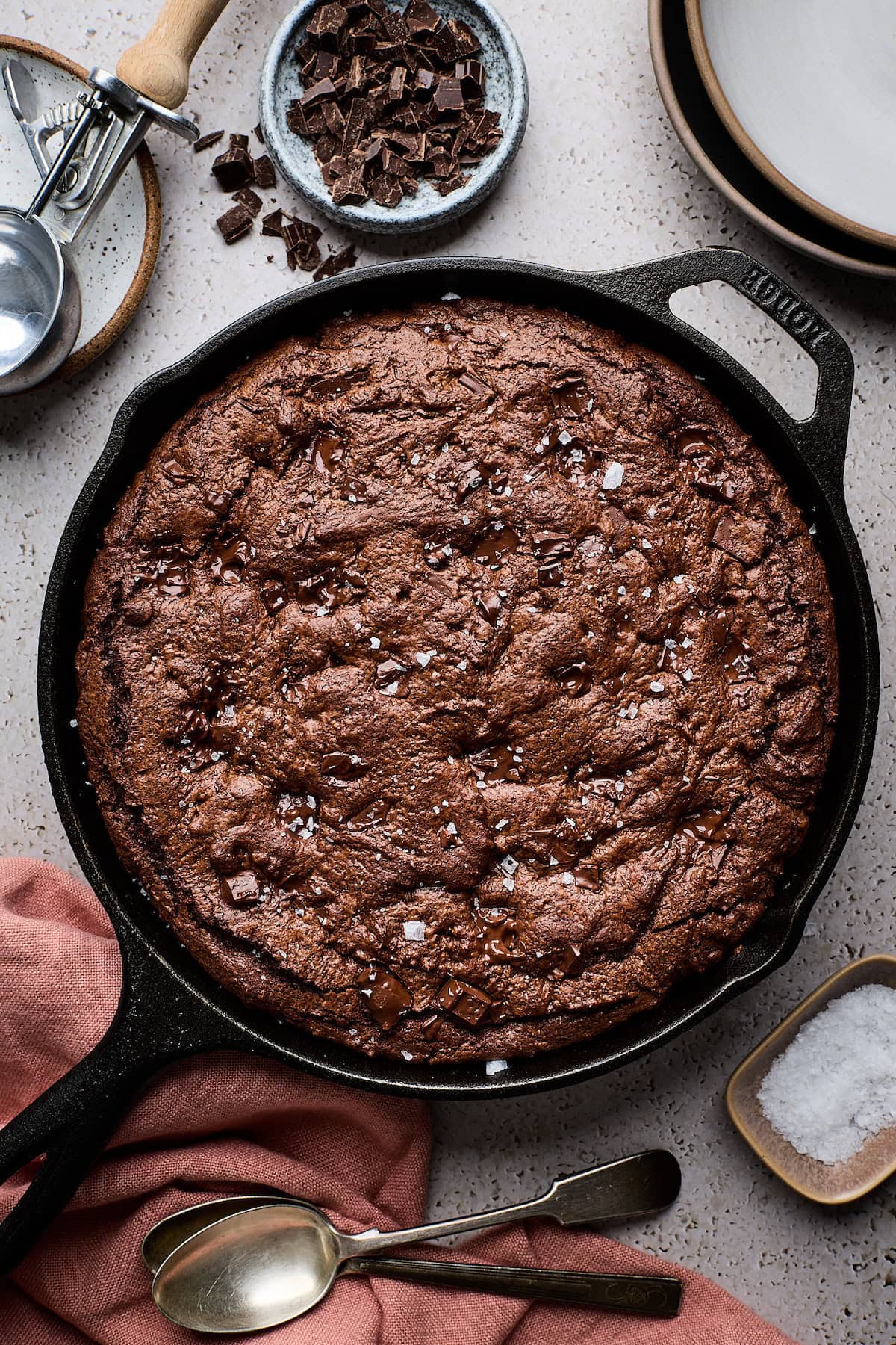 double chocolate skillet cookie with flaky sea salt in cast iron skillet.