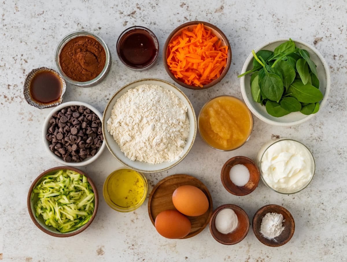 ingredients in bowls to make healthy chocolate vegetable muffins.