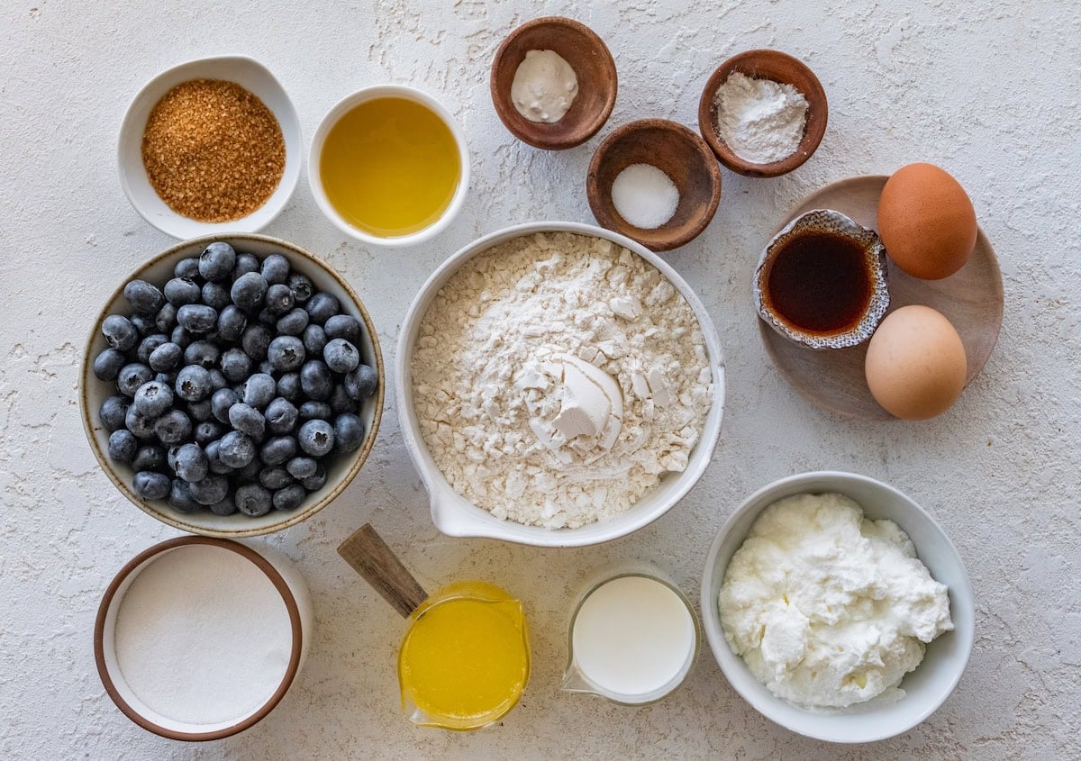 ingredients in bowls to make blueberry yogurt muffins.
