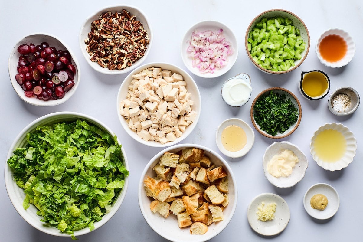 ingredients in bowls to make Chicken Salad with Grapes, Pecans & Croissant Croutons.