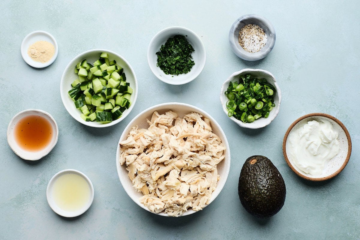 ingredients in bowls to make avocado chicken salad.